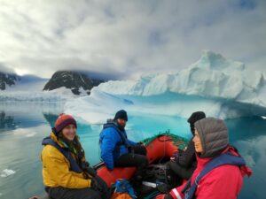 Inflatable boat near iceberg in Antarctica.